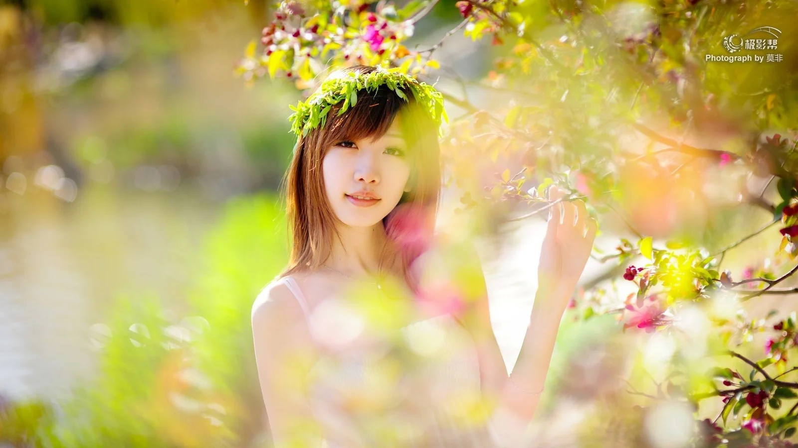 一名女子站在开花的枝叶间，周围映照着温暖柔和的光线。