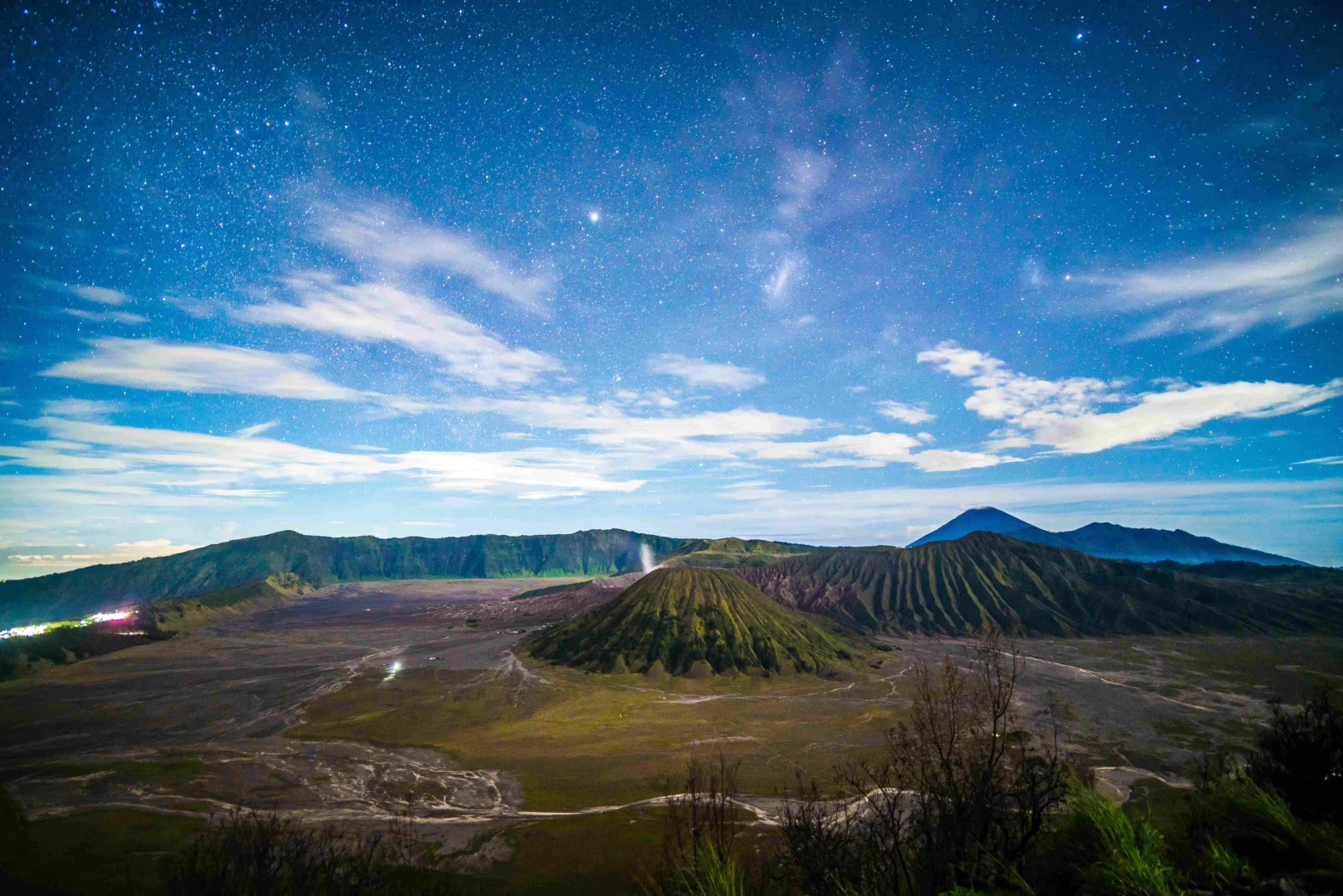 夜空繁星映照着层叠的火山山脉与广阔的荒原。
