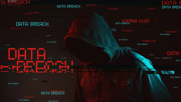 画面中央是带有红蓝光影的兜帽身影，周围布满红色和青色的“DATA BREACH”故障文字。