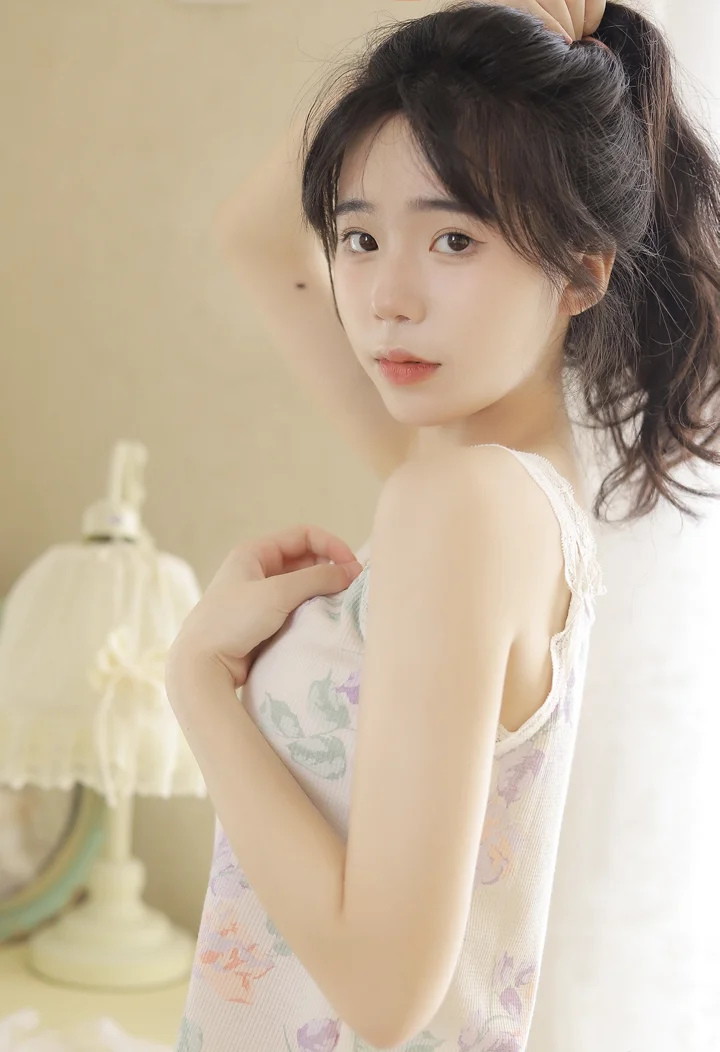 一名成年女性在室内柔和光线下回头看向镜头。